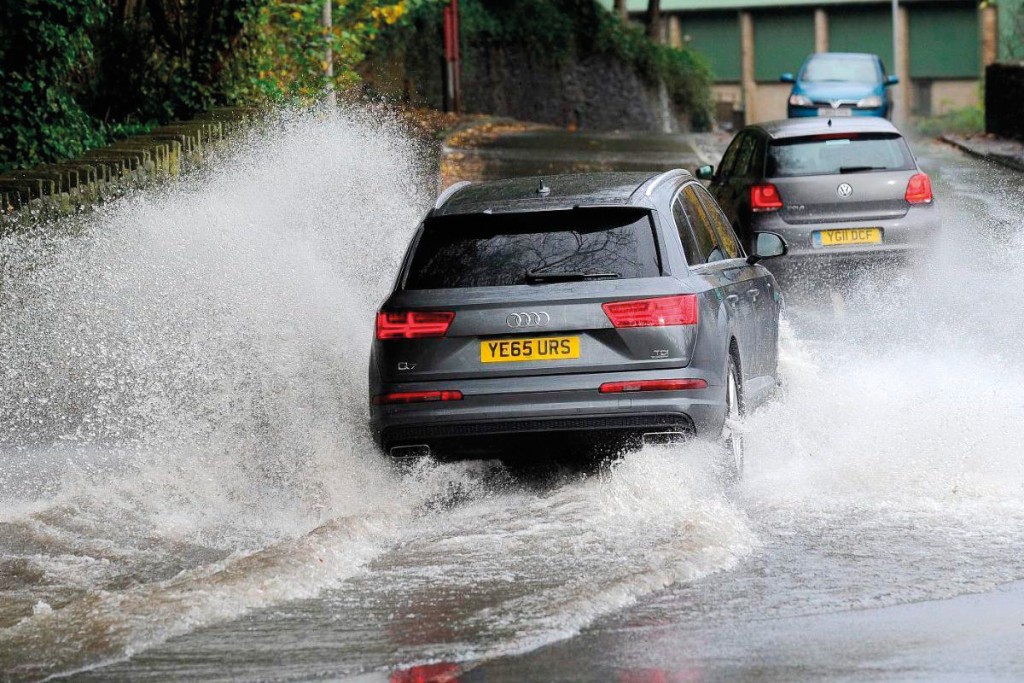 cars driving through flood