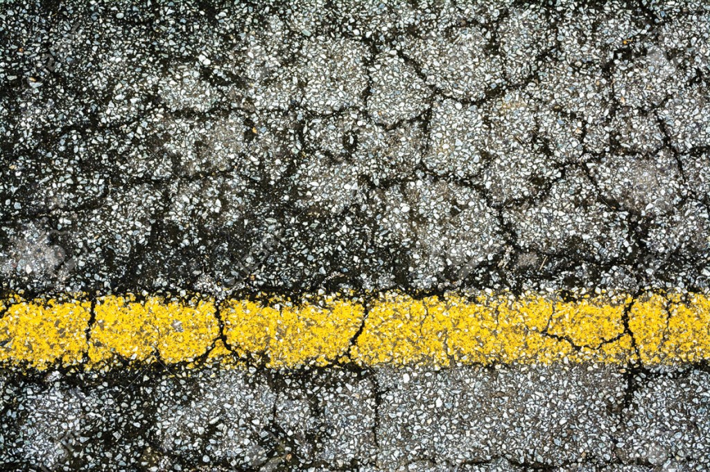 Old yellow line on broken  road texture background