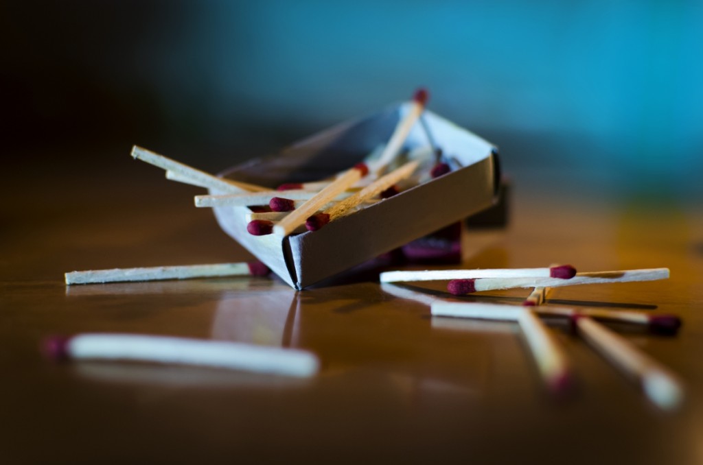 Match box and match sticks lying on floor macro shot indoor in dark depicting concept idea