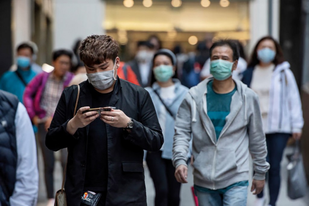 HONG KONG, CHINA - 2020/02/22: Pedestrians wearing face masks as a preventive measure against the Coronavirus, official name covid-19, seen in Central district in Hong Kong. (Photo by Miguel Candela/SOPA Images/LightRocket via Getty Images)