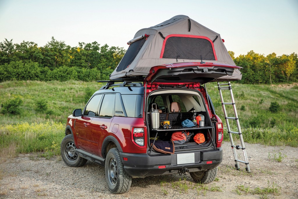 Bronco Sport can quickly help with basecamp setup thanks to an innovative slide-out working table, part of the available five-way configurable Cargo Management System. (Pre-production model pictured.)