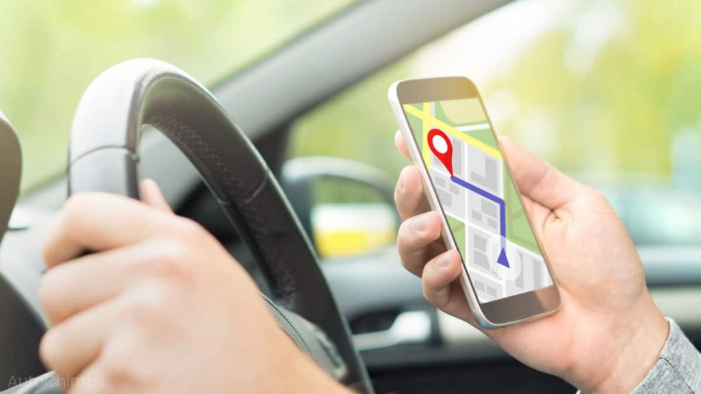 Man-driving-car-with-smart-phone-for-online-map-and-GPS-application